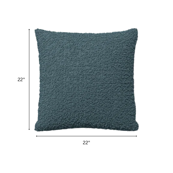 Turquoise bouclé throw pillow with textured loop fabric, square accent pillow on a modern sofa