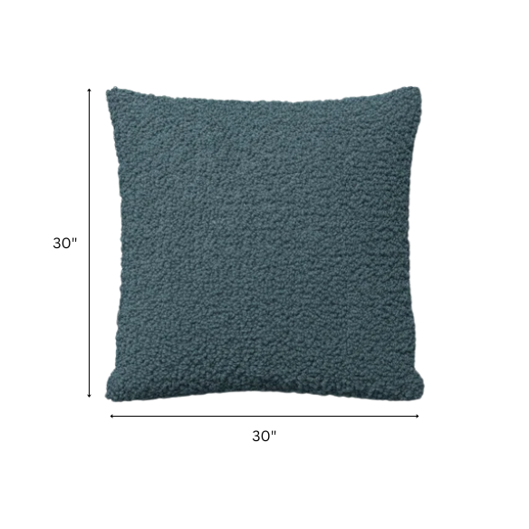 Turquoise bouclé throw pillow with textured loop fabric, square accent pillow on a modern sofa