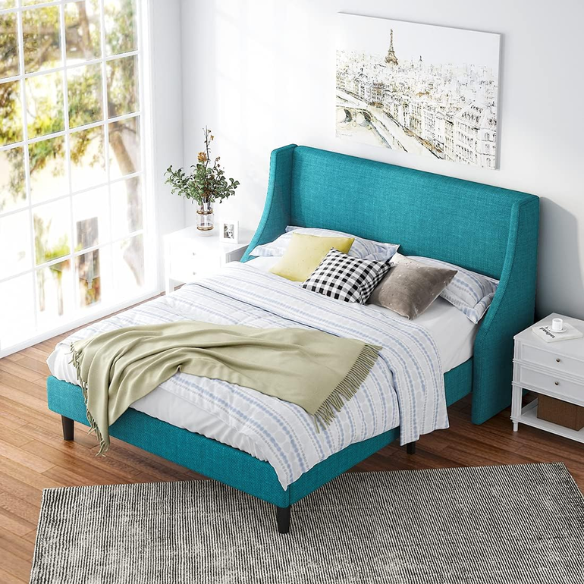 Turquoise linen upholstered queen platform bed with wingback headboard, tapered black legs, and slatted base – no box spring required