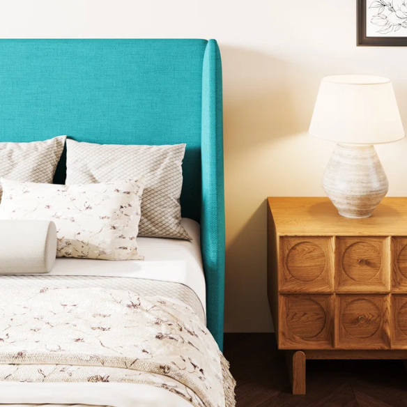 Turquoise linen upholstered queen platform bed with wingback headboard, tapered black legs, and slatted base – no box spring required