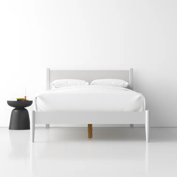 White full-size mid-century modern solid wood platform bed with tapered legs and rectangular headboard