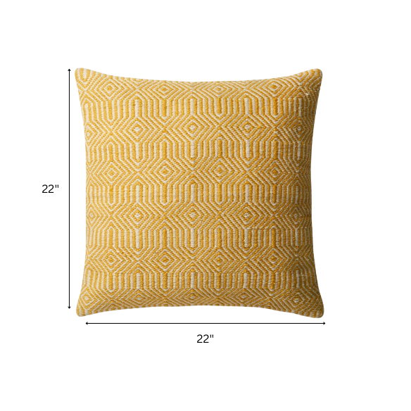 Yellow and cream geometric throw pillow on a bright outdoor chair with summer decor