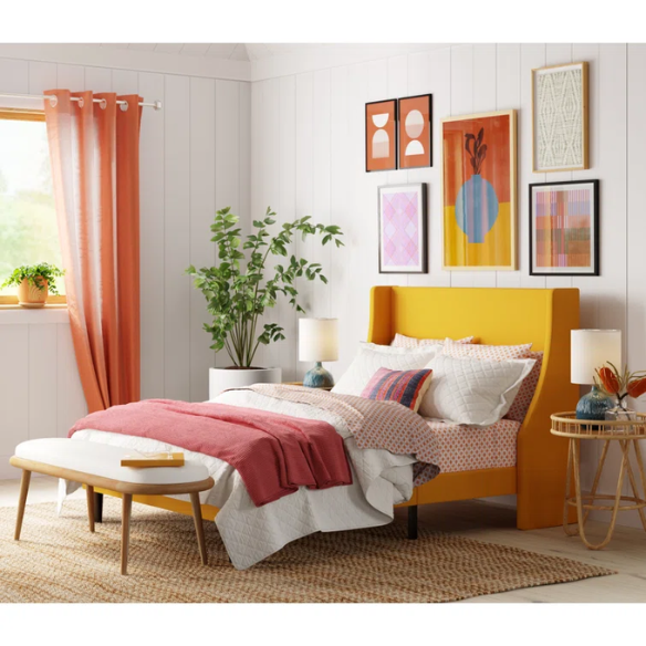 Yellow linen upholstered queen platform bed with wingback headboard, slatted base, and black tapered legs – no box spring required