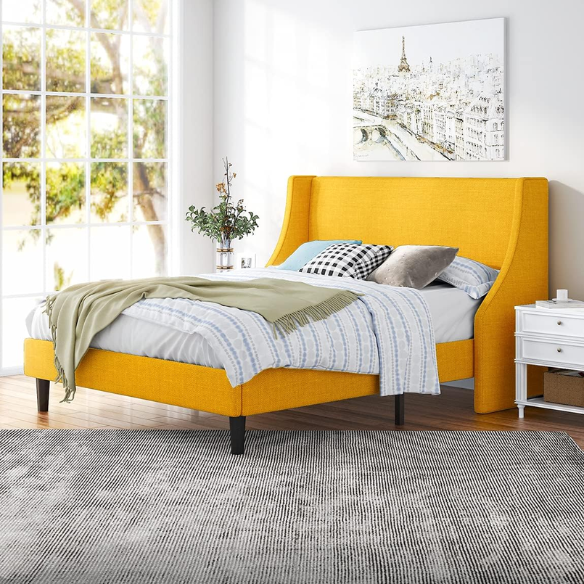 Yellow linen upholstered queen platform bed with wingback headboard, slatted base, and black tapered legs – no box spring required
