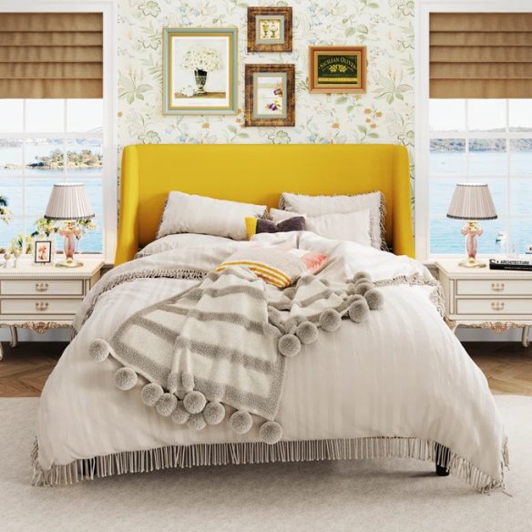Yellow linen upholstered queen platform bed with wingback headboard, slatted base, and black tapered legs – no box spring required