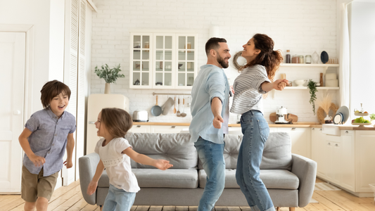 In a spacious and cozy living room, a scene of joyful family activity unfolds.