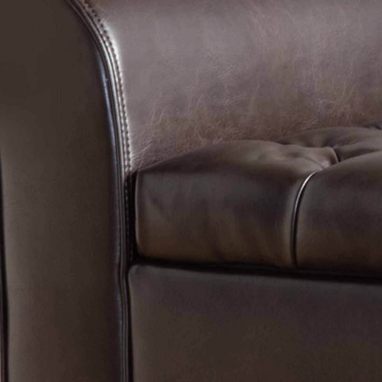 Stylish brown storage ottoman with button-tufted diamond stitch, rolled arms, and spacious interior for pillows and blankets. Crafted from durable PU leather and birch wood, perfect for seating and storage in modern living spaces.