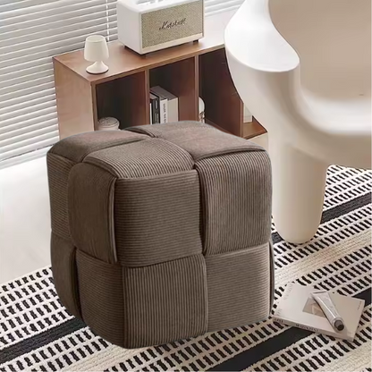 Light chocolate brown corduroy ottoman with cross-stitch design and sturdy wood frame