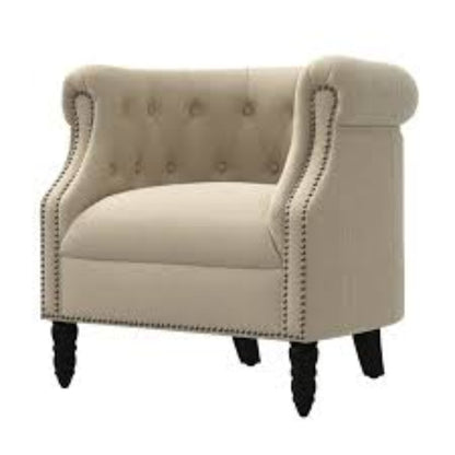 A warm beige mid-century modern accent chair with hand-pulled tufted buttons, silver-toned nailhead accents, and turned wooden legs. The chair features a plush, ergonomic design with foam cushioning and a tufted back for added texture and sophistication. The solid rubberwood frame and durable upholstery ensure long-lasting comfort and support, making it perfect for various rooms including the living room, office, or bedroom.