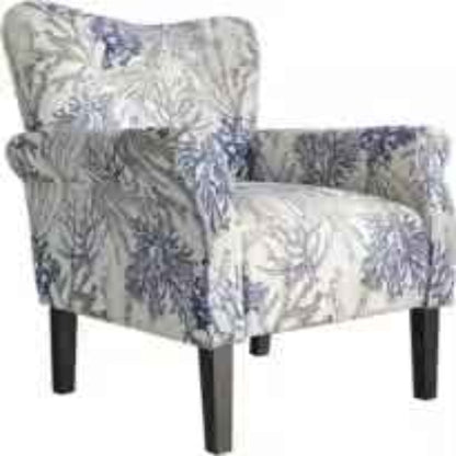 A stylish Blue Coral Accent Chair featuring a vibrant blue coral fabric with a unique pattern. The chair has a tufted wingback design, gracefully tapered wood legs, and padded armrests for optimal comfort. It combines modern sophistication with a classic aesthetic, ideal for any living room, office, or reading nook.