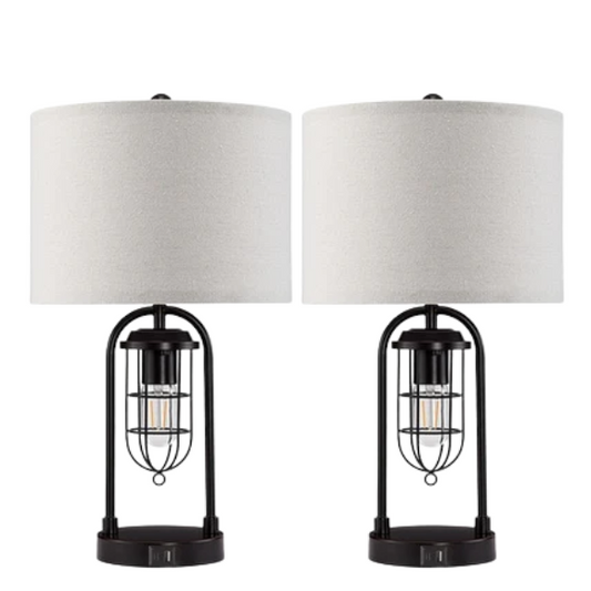 Set of two 21.5-inch espresso table lamps with arch-shaped metal bases, beige fabric drum shades, built-in USB-A and USB-C charging ports, and lantern-style night lights — ideal for modern, industrial, or transitional interiors.

