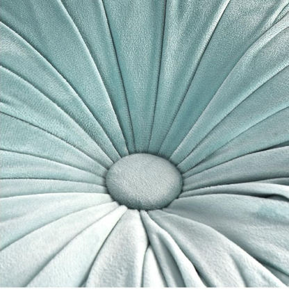 Aqua velvet round throw pillows with hand-sewn pleats and central button, set of two 14.5-inch decorative cushions styled on a modern sofa.

