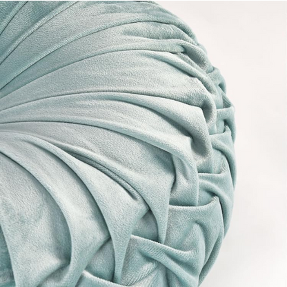 Aqua velvet round throw pillows with hand-sewn pleats and central button, set of two 14.5-inch decorative cushions styled on a modern sofa.

