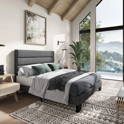 Dark grey upholstered queen platform bed with tufted headboard and wood slat support system