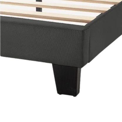 Dark grey upholstered queen platform bed with tufted headboard and wood slat support system