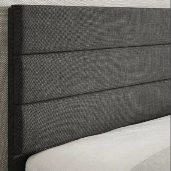 Dark grey upholstered queen platform bed with tufted headboard and wood slat support system
