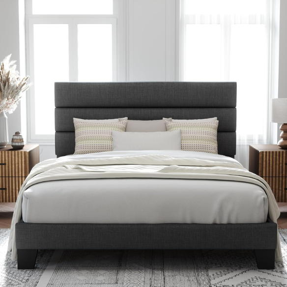 Dark grey upholstered queen platform bed with tufted headboard and wood slat support system