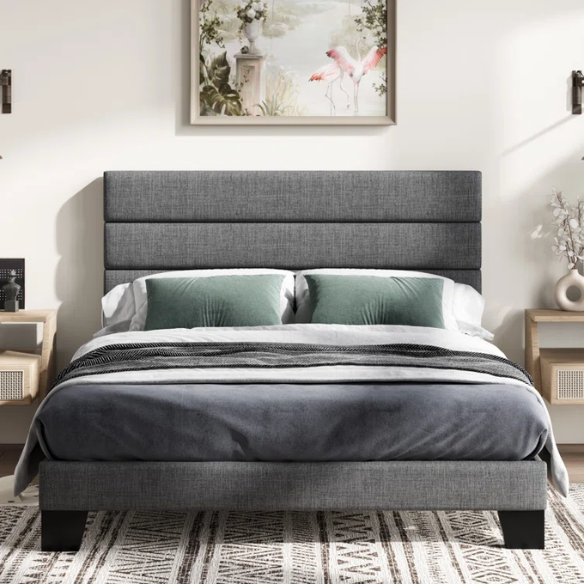 Dark grey upholstered queen platform bed with tufted headboard and wood slat support system