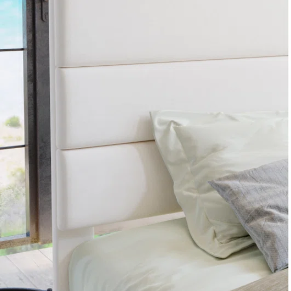 White upholstered queen platform bed with tufted headboard and wood slat base, no box spring required