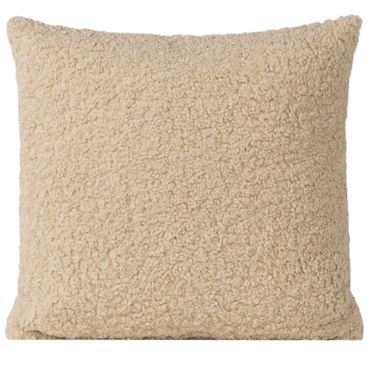 Beige bouclé throw pillow with looped textured fabric, square accent pillow on a neutral-toned sofa

