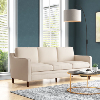 Beige chenille upholstered sofa with curved track arms, loose back cushions, and brown tapered wood legs, in a mid-century modern design.