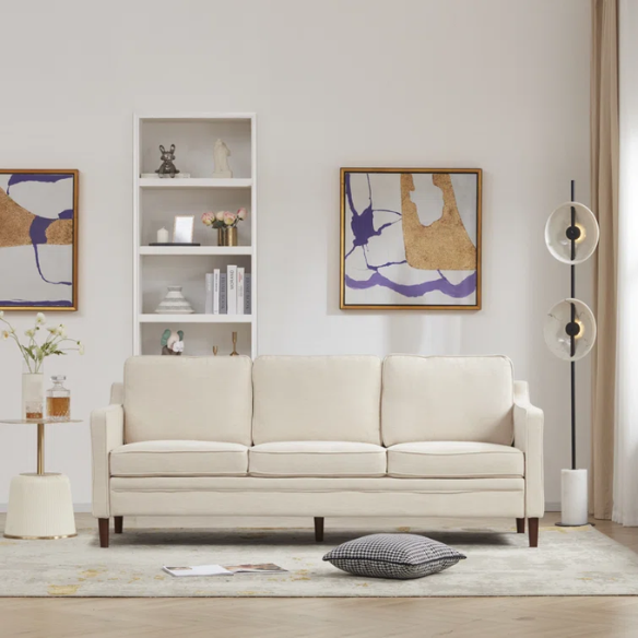 Beige chenille upholstered sofa with curved track arms, loose back cushions, and brown tapered wood legs, in a mid-century modern design.