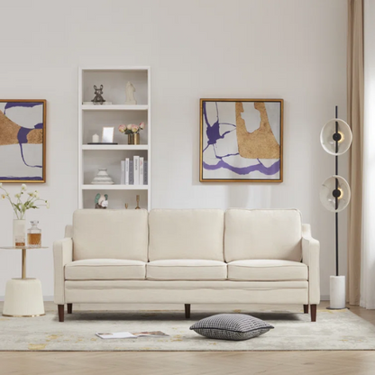 Beige chenille upholstered sofa with curved track arms, loose back cushions, and brown tapered wood legs, in a mid-century modern design.