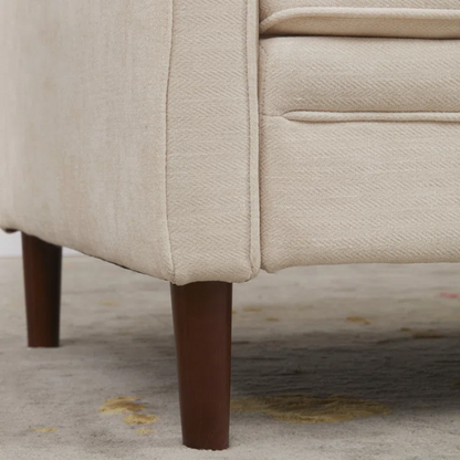 Beige chenille upholstered sofa with curved track arms, loose back cushions, and brown tapered wood legs, in a mid-century modern design.