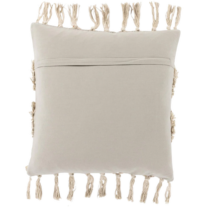 Beige and cream boho accent pillow with tassels and striped texture on a cozy neutral-toned sofa

