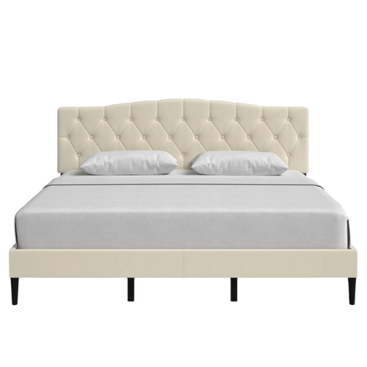 Beige king-size upholstered platform bed with camelback tufted headboard, foam padding, and low-profile wood frame with underbed clearance


