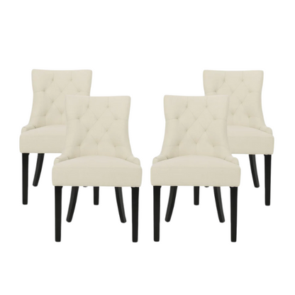 Set of four beige upholstered dining chairs featuring diamond tufting, armless design, sloped sides, and espresso brown wooden legs.