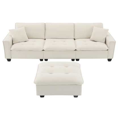 Beige suede L-shaped sectional sofa with removable ottoman, tufted seat cushions, and two matching accent pillows