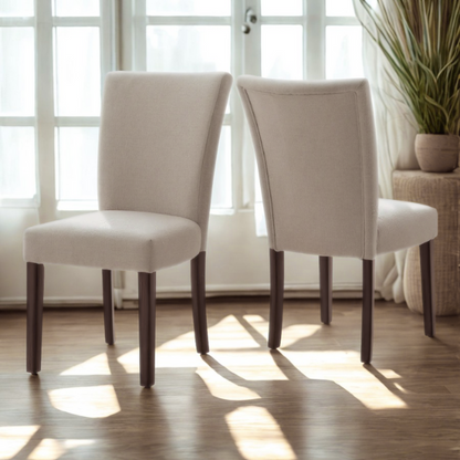 Set of 2 upholstered Parson dining chairs in beige fabric with espresso-finished wood legs and high backs, perfect for traditional and modern dining rooms.

