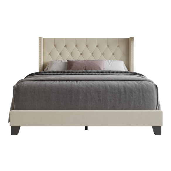 Beige full-size upholstered bed with wingback tufted headboard and nailhead trim
