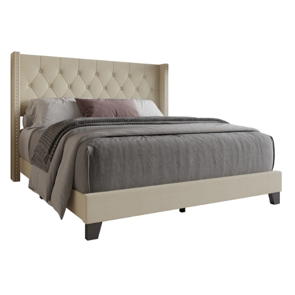 Beige full-size upholstered bed with wingback tufted headboard and nailhead trim