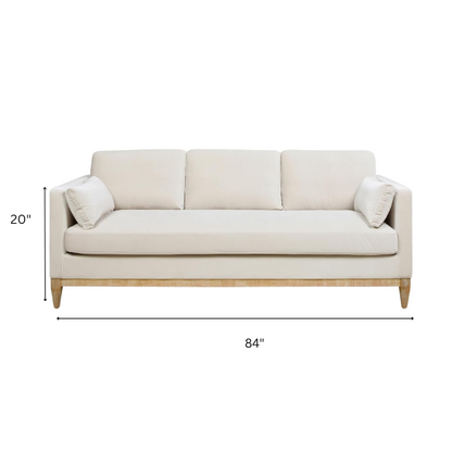 Beige velvet 3-seater sofa with square track arms, feather-down cushions, and natural wood legs, ideal for modern and transitional living rooms.

