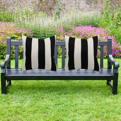 Striped accent pillow in black and cream – weather-resistant and reversible with plush polyester fill, ideal for indoor or outdoor use on patios, decks, or sofas.

