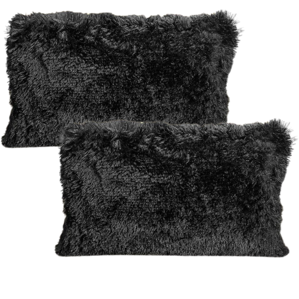 Set of two black faux fur throw pillows with white-tipped shaggy texture on a modern neutral-toned sofa

