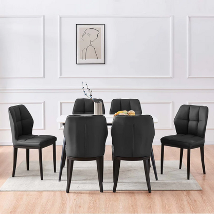 Set of two mid-century modern black faux leather dining chairs with checkered stitching and metal legs