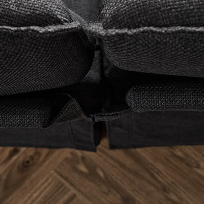 Black modular cloud sofa with deep foam cushions, pillow top arms, and matching ottoman