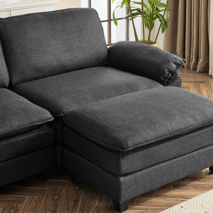 Black modular cloud sofa with deep foam cushions, pillow top arms, and matching ottoman