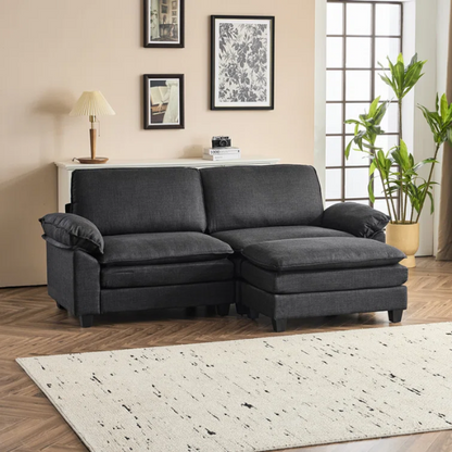 Black modular cloud sofa with deep foam cushions, pillow top arms, and matching ottoman