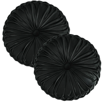 Black velvet round throw pillows with hand-sewn pleats and central button, set of two 14.5-inch plush decorative cushions styled on a modern neutral sofa.

