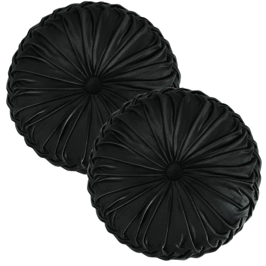 Black velvet round throw pillows with hand-sewn pleats and central button, set of two 14.5-inch plush decorative cushions styled on a modern neutral sofa.

