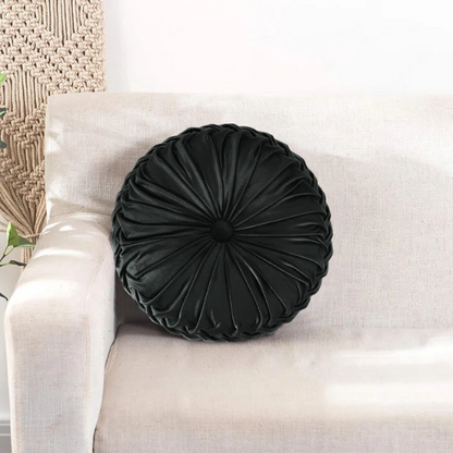 Black velvet round throw pillows with hand-sewn pleats and central button, set of two 14.5-inch plush decorative cushions styled on a modern neutral sofa.

