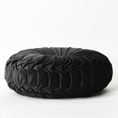 Black velvet round throw pillows with hand-sewn pleats and central button, set of two 14.5-inch plush decorative cushions styled on a modern neutral sofa.

