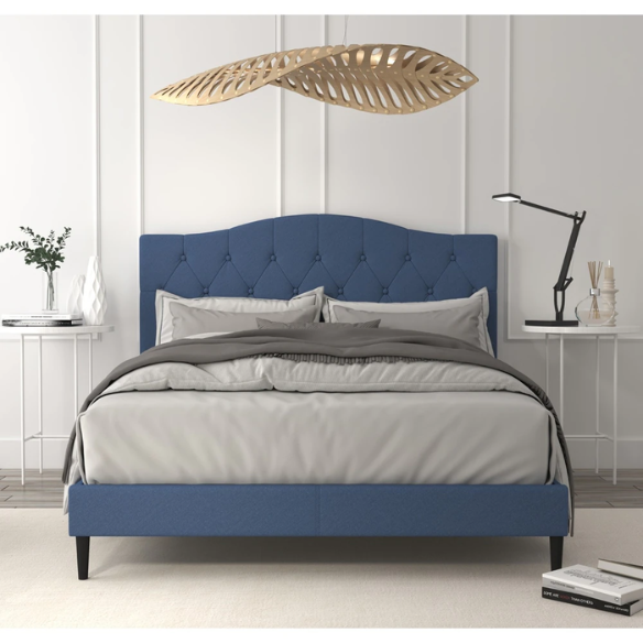Blue upholstered king-size platform bed with tufted camelback headboard, solid wood frame, and slatted base with center support legs

