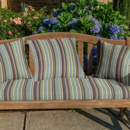 Striped accent pillow in blue, olive green, and beige – reversible, weather-resistant, and overstuffed with plush polyester fill for stylish indoor or outdoor comfort.

