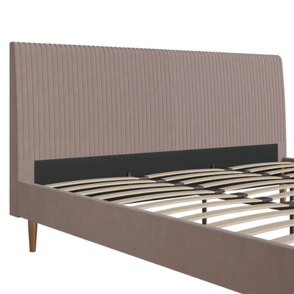 Blush pink velvet upholstered king-size platform bed with padded rectangular headboard, solid wood slats, and elegant low-profile frame.

