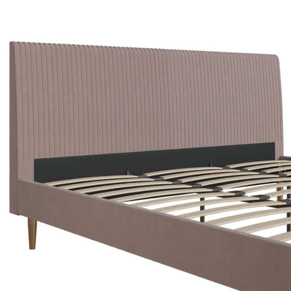 Blush pink velvet upholstered king-size platform bed with padded rectangular headboard, solid wood slats, and elegant low-profile frame.

